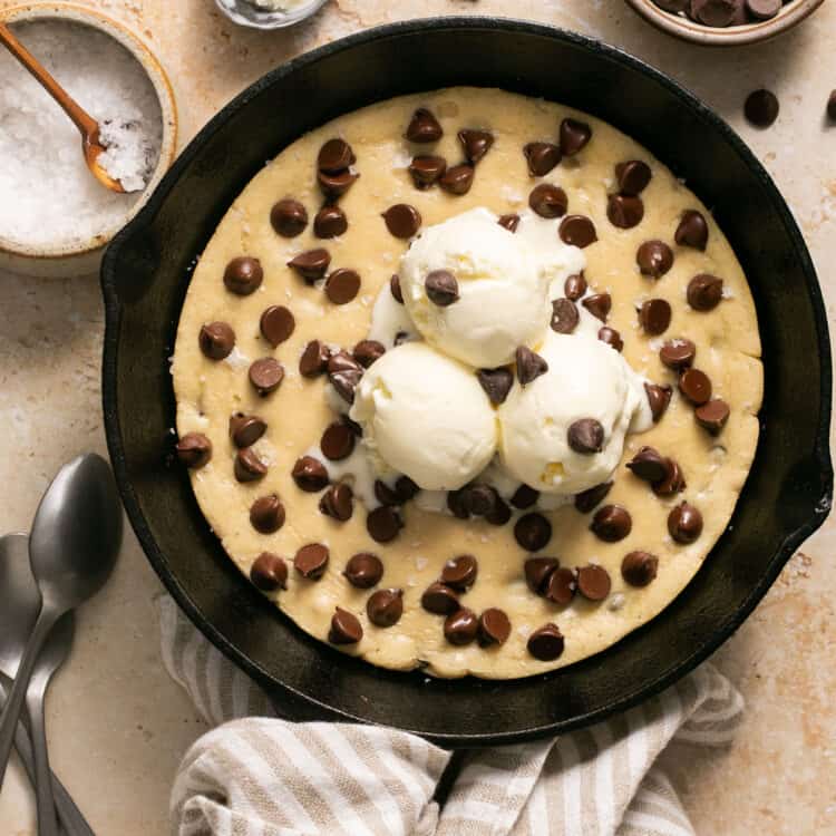 Protein skillet cookie topped with ice cream in a skillet.