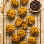 Healthy chocolate chip pumpkin muffins on a cooling rack.