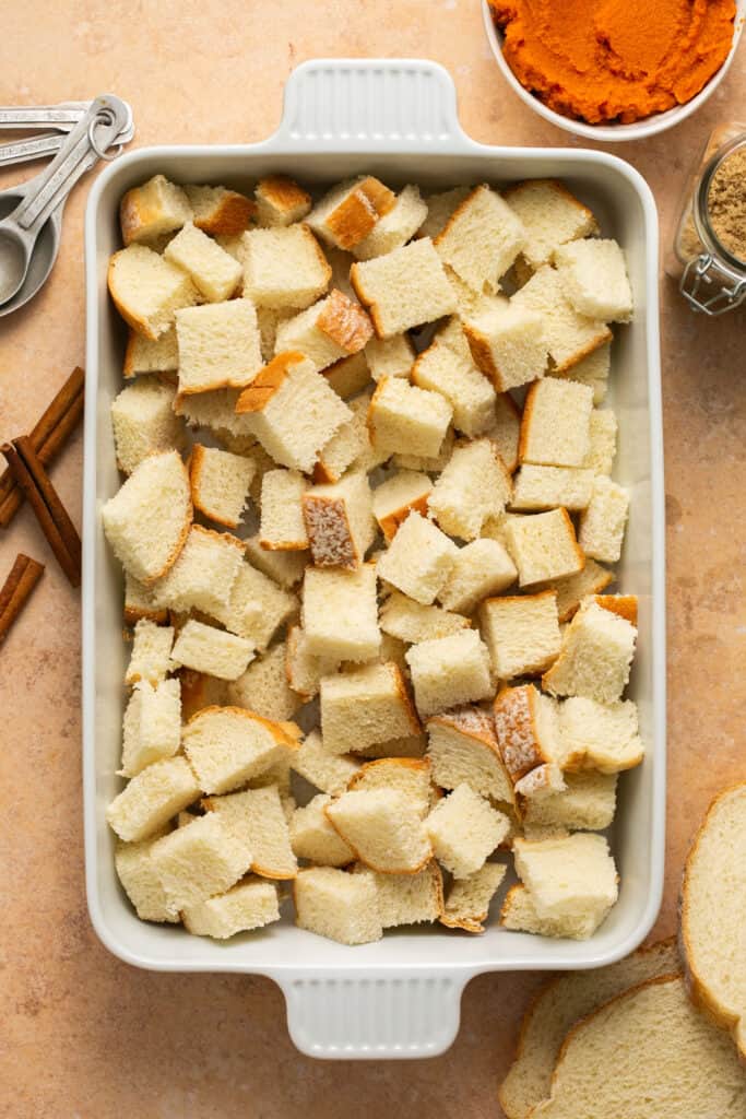 Cubes of bread in a baking dish.