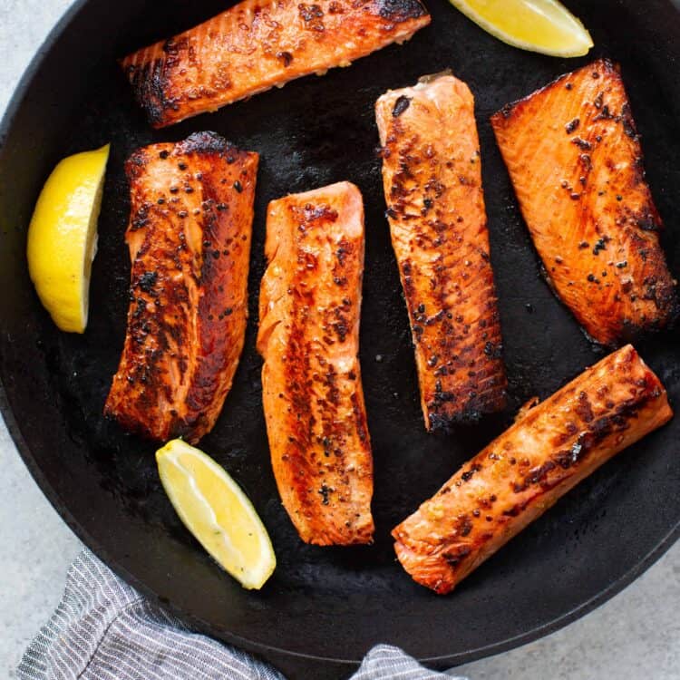 Honey garlic salmon recipe with lemon spices in a skillet.