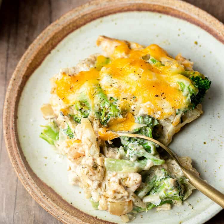Chicken broccoli hashbrown casserole on a plate with a fork.