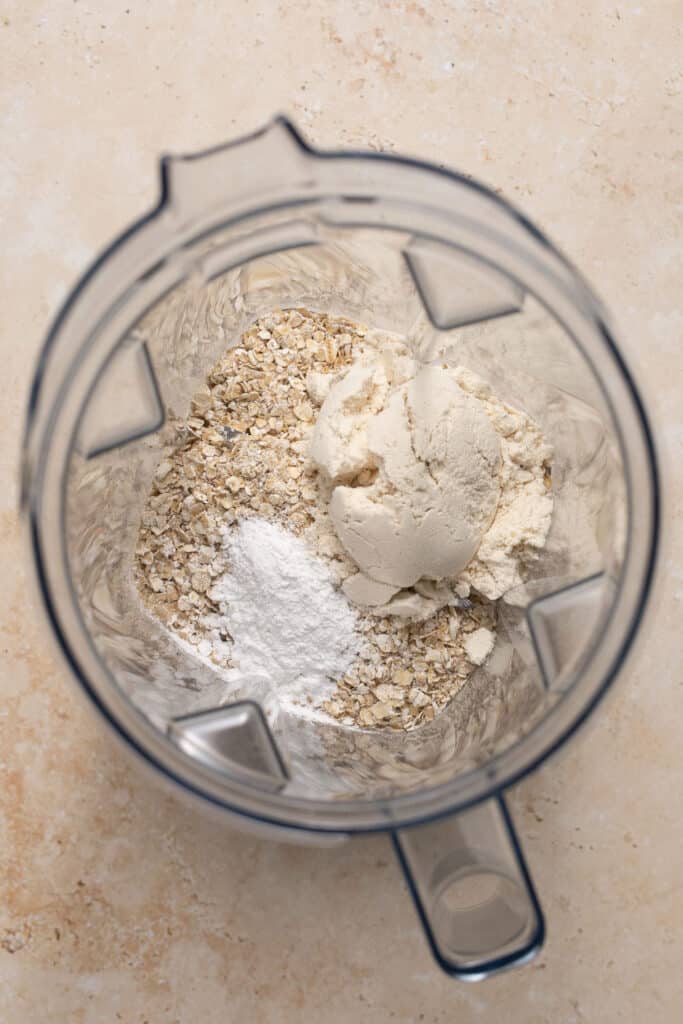 Dry ingredients in the bowl of a food processor.