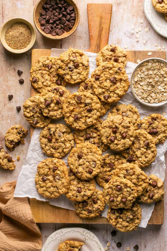 Oatmeal Chocolate Chip Lactation Cookies (Without Brewer's Yeast) on a cutting board with parchment paper.