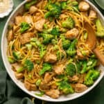 Sesame noodles with chicken and broccoli on a plate.