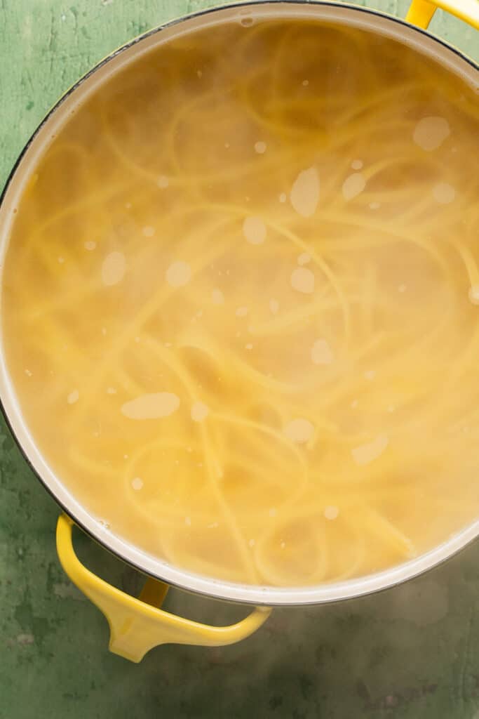 Pasta cooking in a pot of boiling water.
