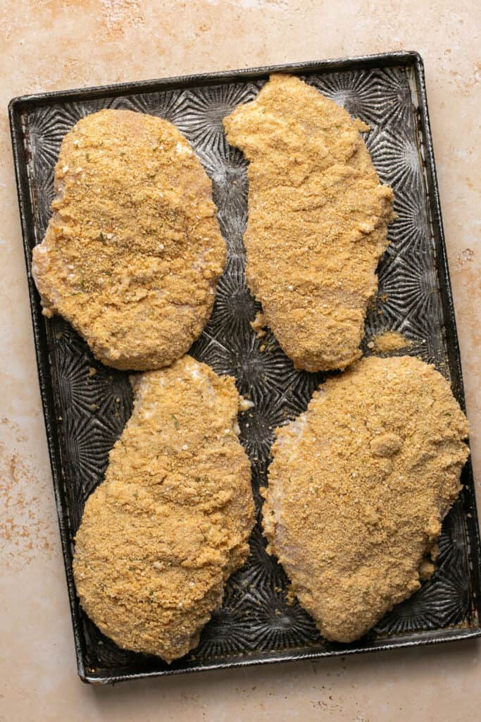 Meal Prep Breaded Chicken on a baking sheet before being baked.