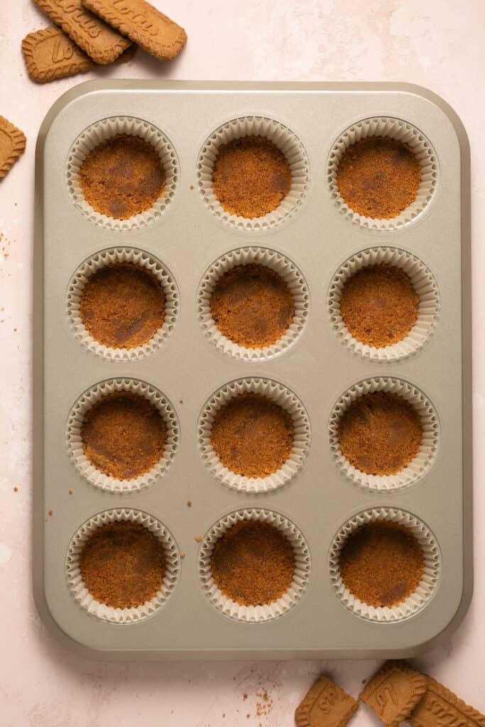 Biscogg mixture placed in the bottoms of a 12 cup muffin pan.