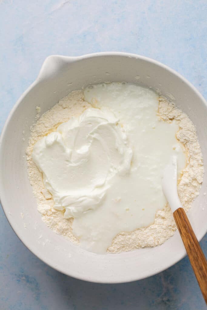 Greek yogurt addeed to the ingredients in the mixing bowl.