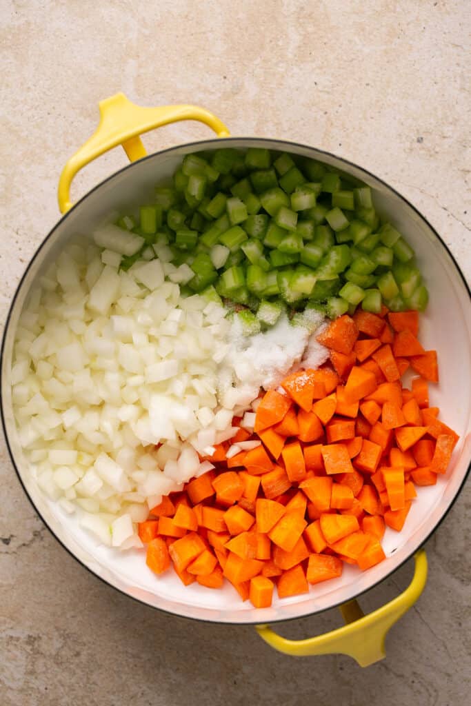 Chopped onion, carrots, and celery in a dutch oven.
