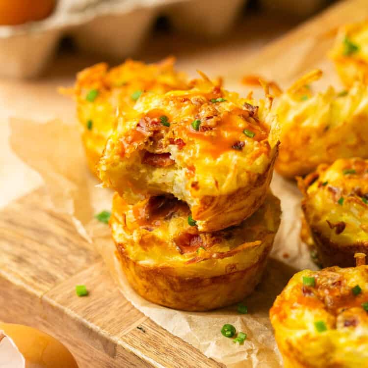 Hash brown egg nests on a cutting board.