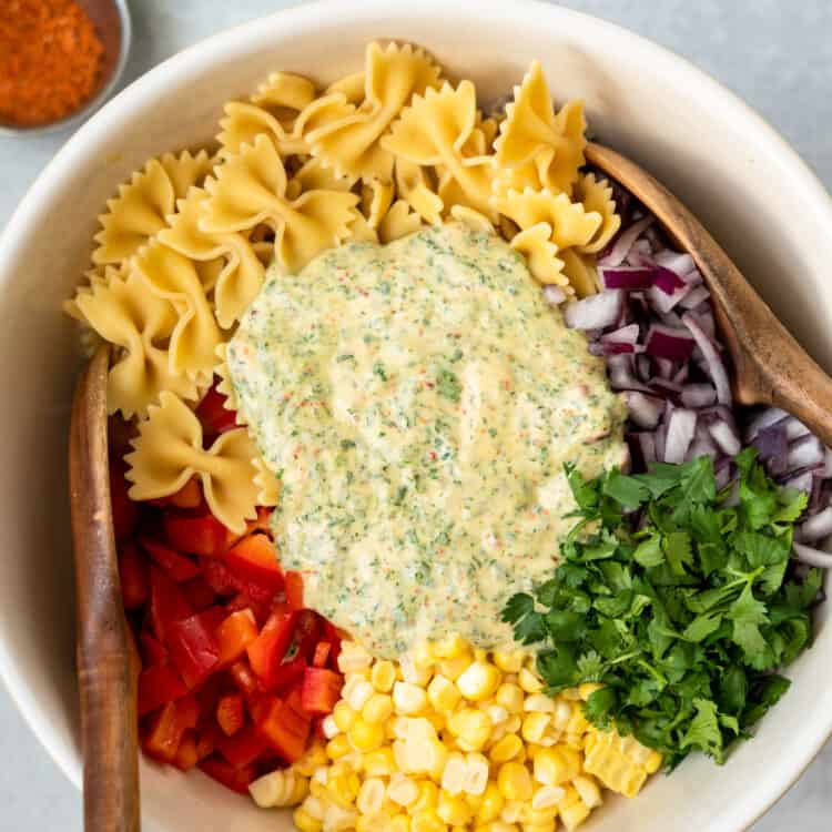Pasta salad ingredients in a large bowl after before being combined.