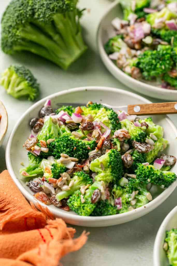 Healthy broccoli salad with greek yogurt in a bowl with a fork.