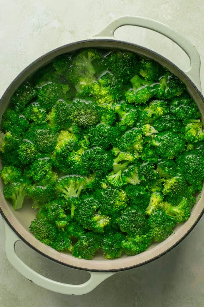 Chopped broccoli in a pot with water.