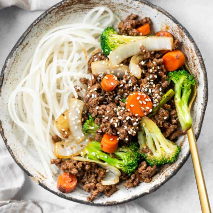 Beef stir fry with soba noodles on a plate.