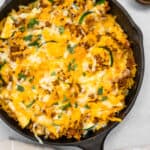 Yellow rice and ground turkey skillet topped with shredded cheese.