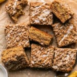 Banana sour cream coffee cake cut iinto squares on a cutting board.