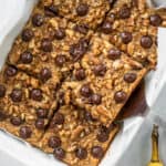Chunky monkey banana baked oatmeal in a baking dish cut into squares.