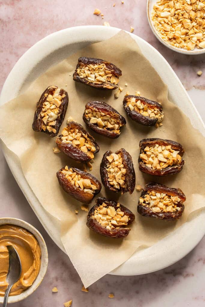 Dates stuffed with peanut butter and chopped peanuts.