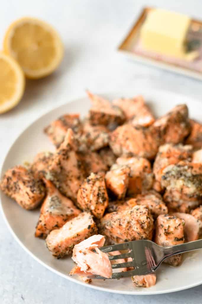 Lemon butter salmon bites on a plate with a fork.
