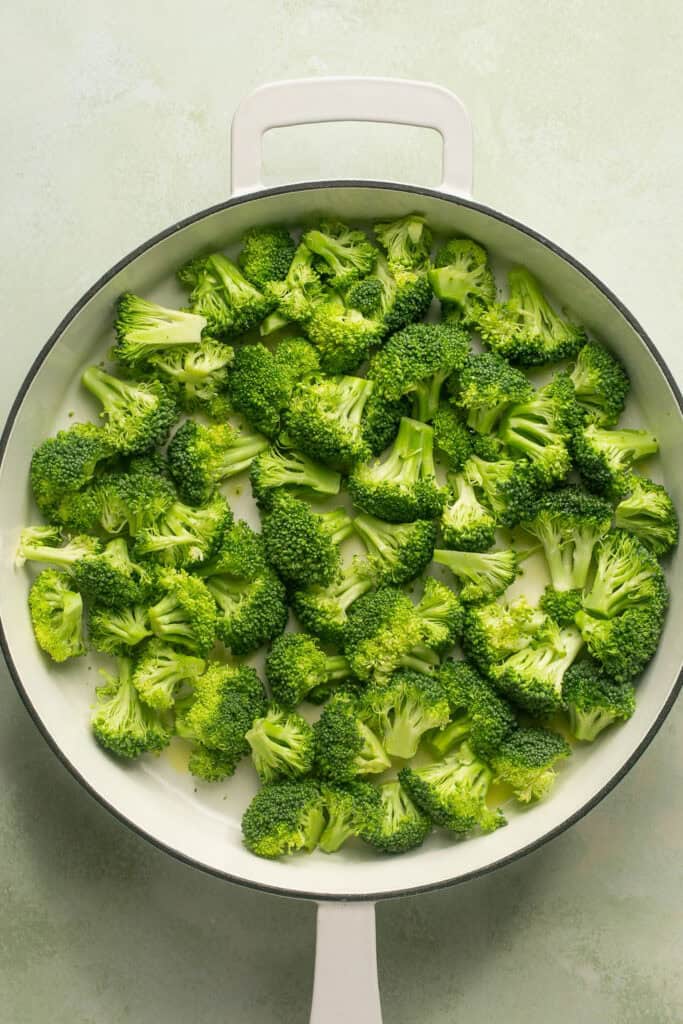 Chopped broccolli in a skillet.