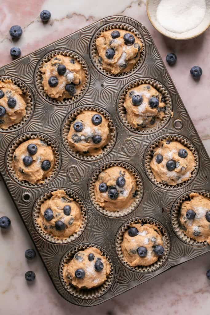 Greek yogurt muffin batter in a muffin pan.