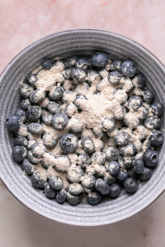 Blueberries tossed with flour in a small bowl.