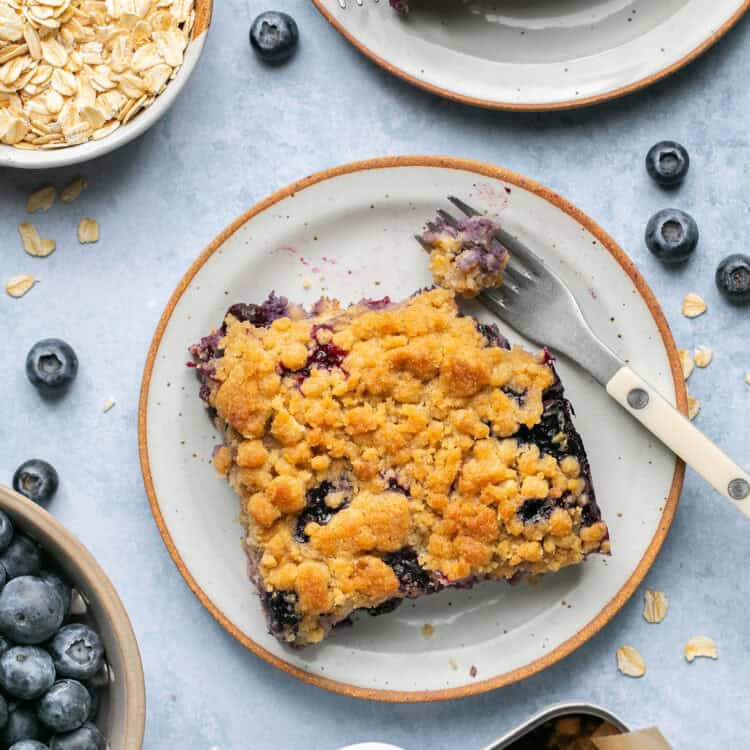 Blueberry muffin baked oatmeal on small plates with forks.