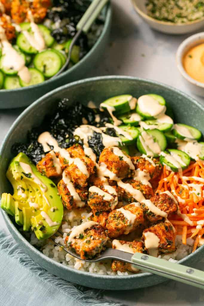 Air fryer salmon sushi bowl drizzled with spicy mayo.