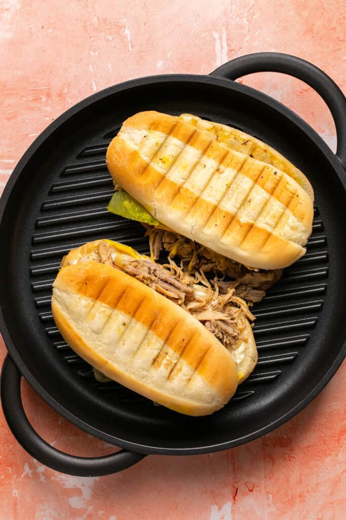 Cuban pulled pork sandwiches on a grill pan.