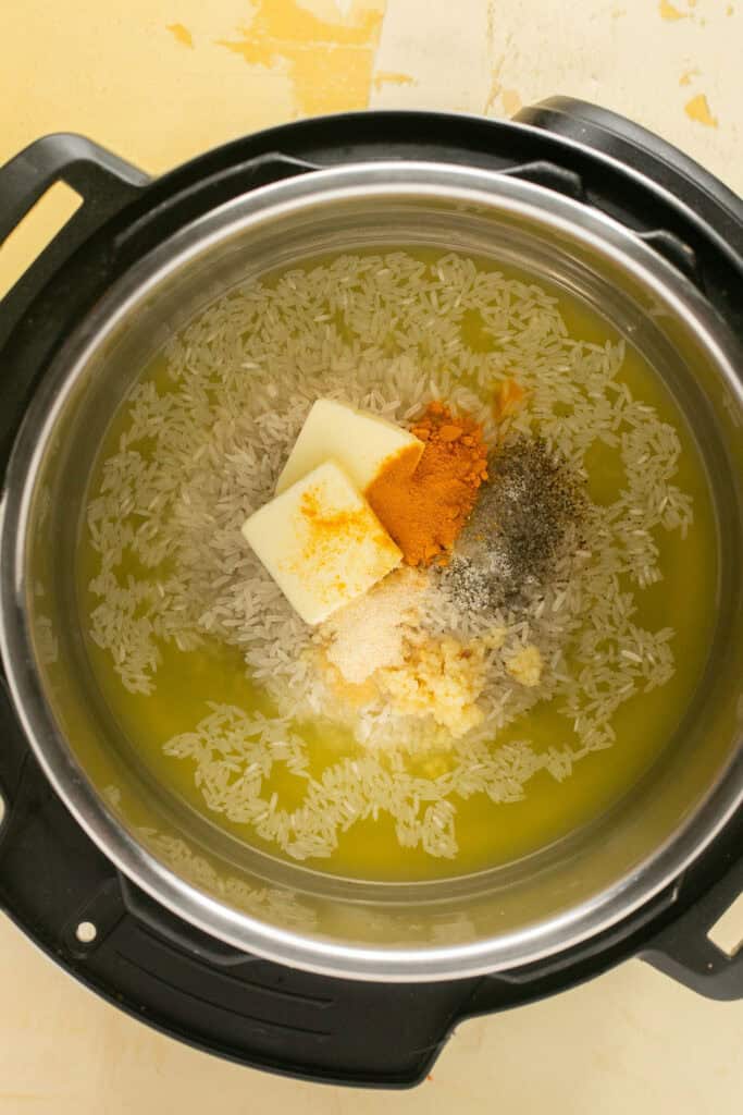 Ingredients for instant pot yellow rice in an instant pot.