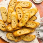 Crostini crackers recipe on a serving tray.