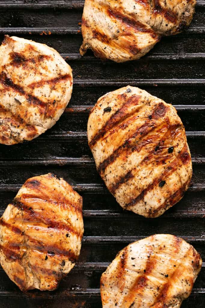 Cooked chicken breasts on a grill plate.