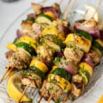 Lemon garlic chicken skewers on a serving platter.