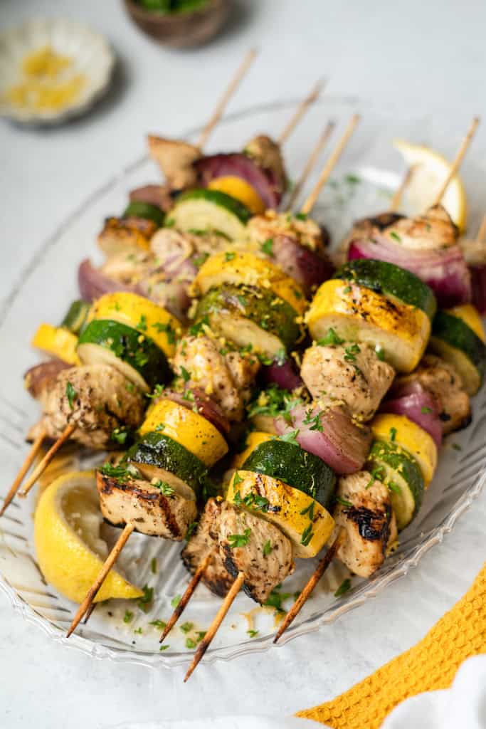 Lemon garlic chicken skewers on a serving platter.