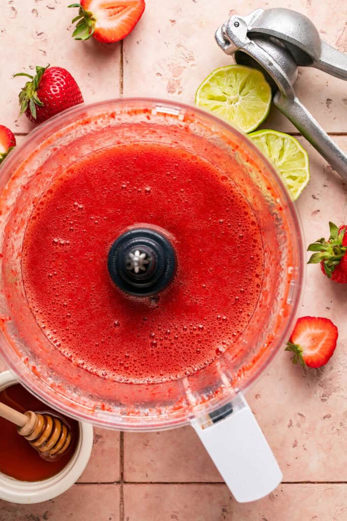 Strawberry puree in a food processor bowl.