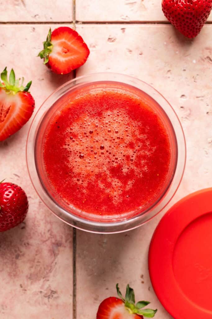 Strawberry mixture in a creami pint.