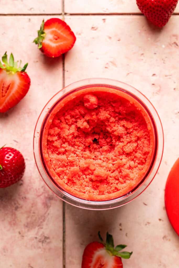 Frozen strawberry mixture in a creami pint.