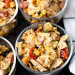 Grilled chicken pasta salad in glass bowls.