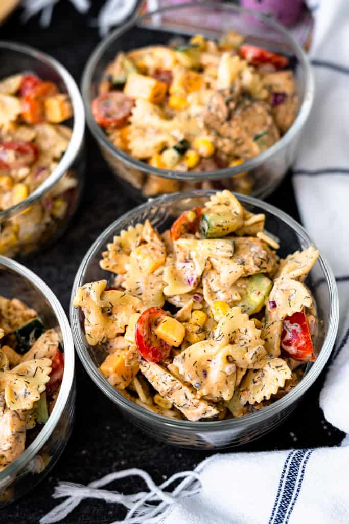 Grilled chicken pasta salad in glass bowls.