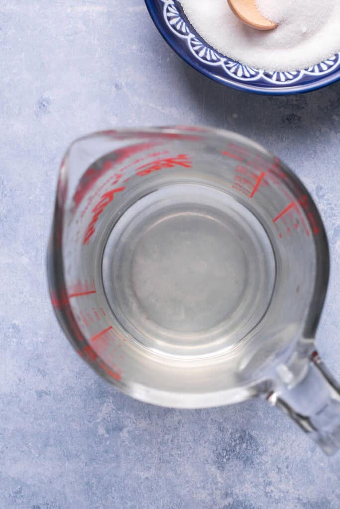 Vinegar for sushi in a glass measuring cup.