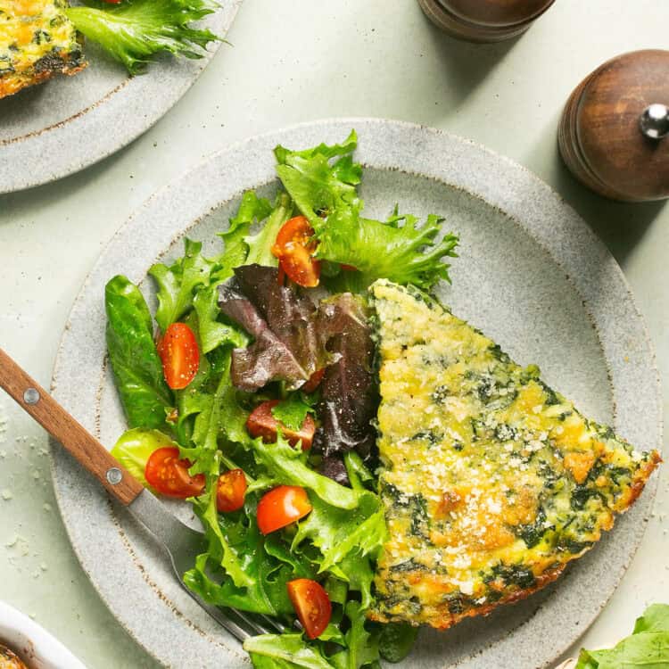 Cottage cheese egg bake with a side of greens on a plate.