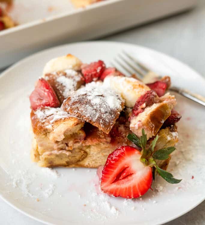 Strawberries and cream french toast bake on a small plate with a fork.