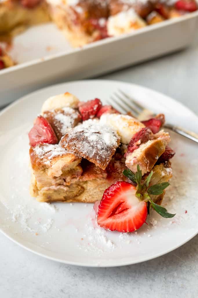 Strawberries and cream french toast bake on a small plate with a fork.