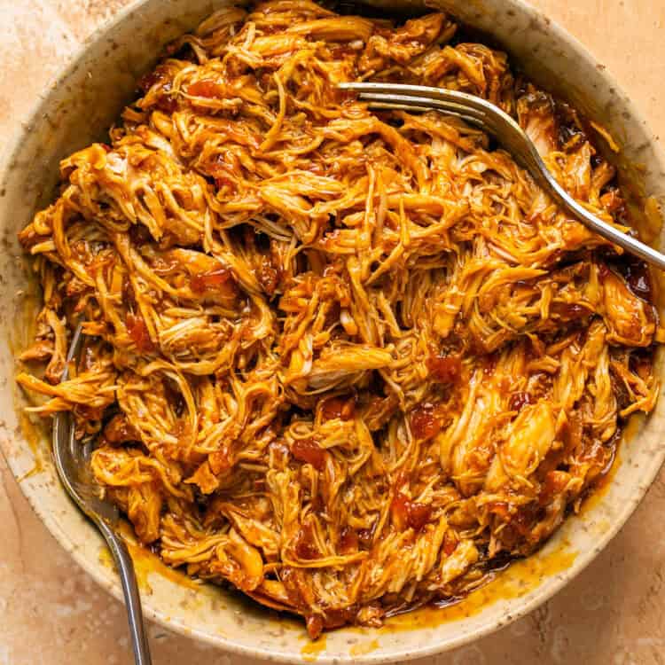 Shredded Teriyaki Chicken in a bowl with two forks.