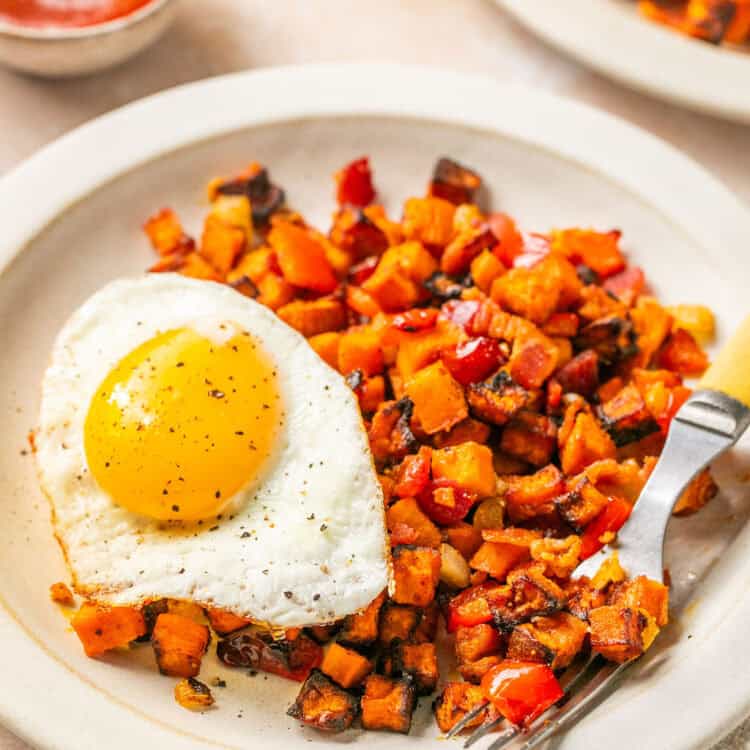 Air Fryer Sweet Potato Hash on a plate with an egg.