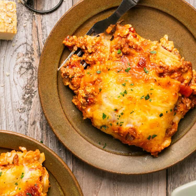 Cottage cheese lasagna on small plates with forks.