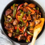 Honey Balsamic Chicken Pepper Skillet in skillet with a wooden spoon.