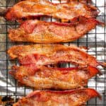 Bacon on a cooling rack on a sheet pan lined with foil.