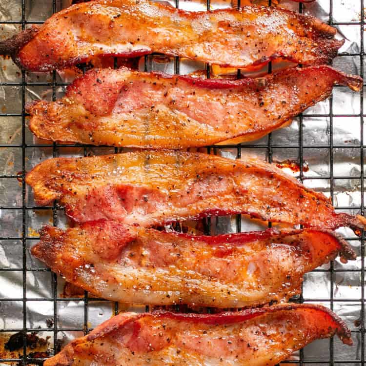 Bacon on a cooling rack on a sheet pan lined with foil.