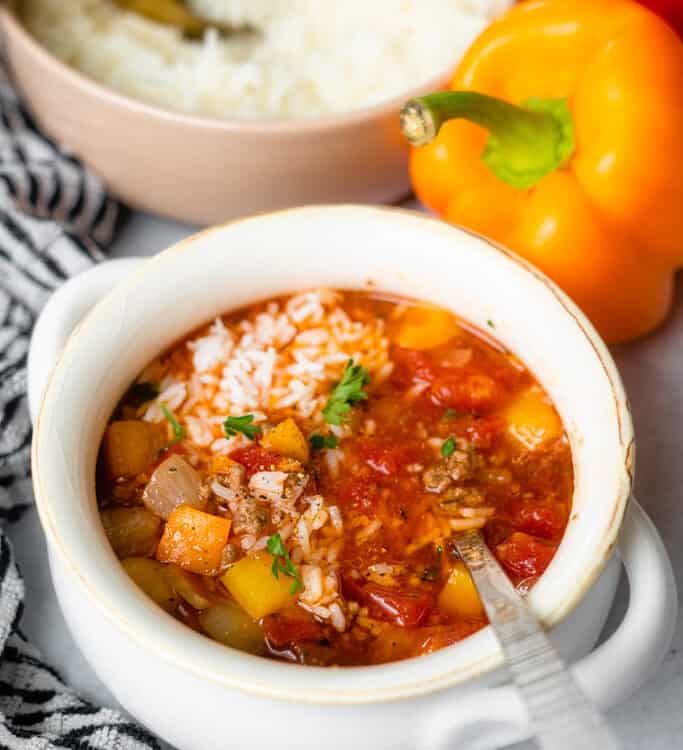 Stuffed pepper soup in a bowl with a spoon.